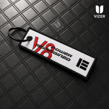 V8 BLACK/WHITE KEYCHAIN WITH METAL KEY RING